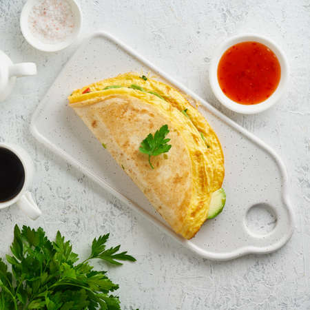 Trendy breakfast with quesadilla and eggs, trending food with omelet, cheeseの写真素材