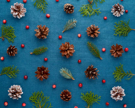 Christmas and Happy New Year dark blue background. Pattern with fir branches, cones, cranberryの写真素材
