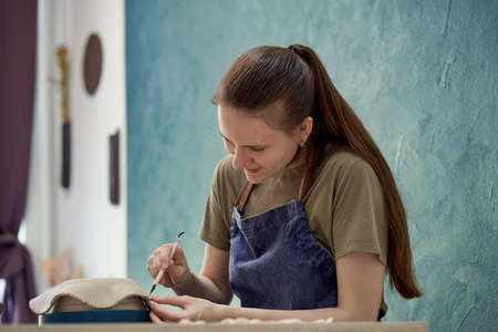 Young girl making ceramic bowl in class. Creative hobby conceptの写真素材