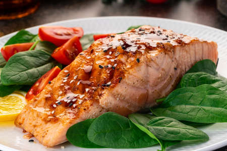 Baked or fried salmon and salad, Paleo, keto, fodmap, dash diet. Mediterranean food with steamed fish. Oven asian dish with teriyaki. Healthy concept, gluten free, lectine free, side viewの写真素材
