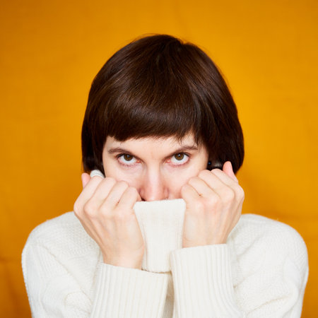Portrait of mature woman in distress, close-up. Agitated tensed face. Look at camera. Middle-aged female, adult experienced woman looking uncertainly into future, loss of control over life.の写真素材
