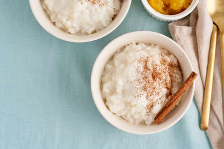 Rice pudding. Comfort winter food. French milk rice porridge dessert. Two bowl healthy vegan gluten...