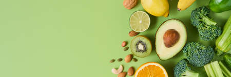 Banner of healthy and nutritious vegetables, fruits and nuts on light green background, copy space....