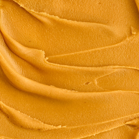 Tasty peanut butter smear macro shot. Closeup of textured smooth nut food