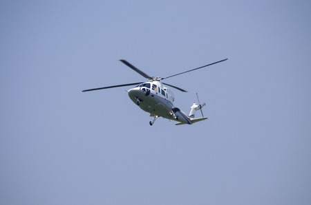 helicopter flies in the sky