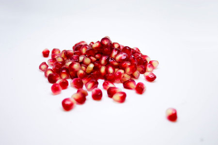 pomegranate seeds on a white backgroundの写真素材
