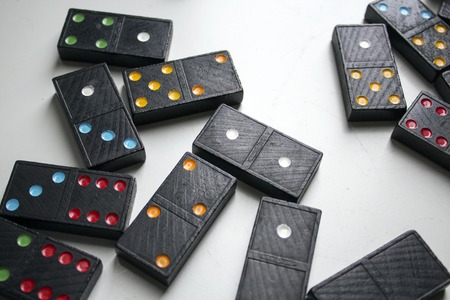 Black dominoes with colorful dotsの写真素材