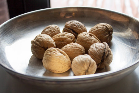 Some walnuts on metal plateの写真素材