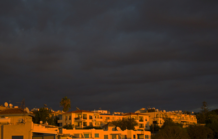 Dark sky before thunderstorm in the light of sunsetの写真素材