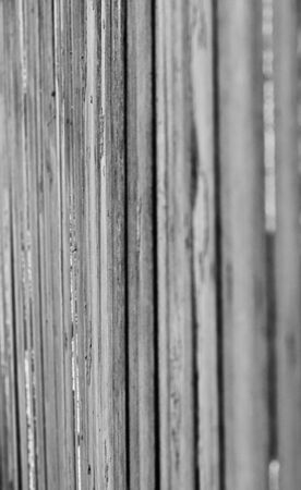 Old fence made of boards. Wooden texture, background. Black and white toning