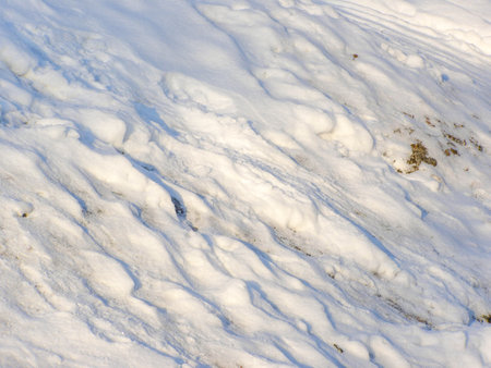 Snow covered slope illuminated by the bright sun. winter dayの写真素材