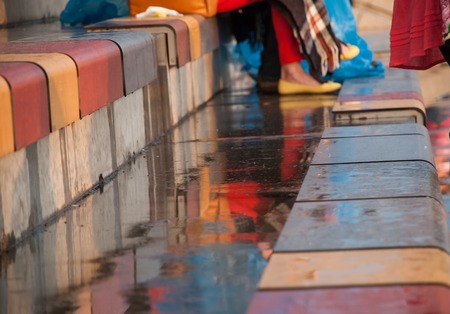 Multicolored wet seats in the stands after a rain