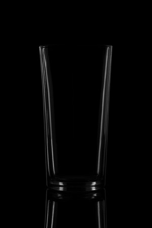 Empty glass on black background with reflectionの写真素材