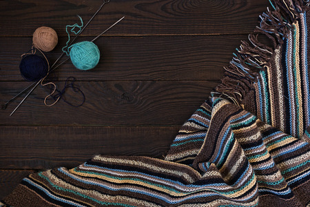 Fragment of handmade knitted fabric, knitting needles and ballsの写真素材