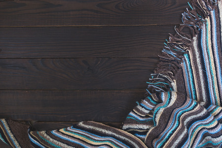 Fragment of handmade knitted fabric with stripes and fringeの写真素材