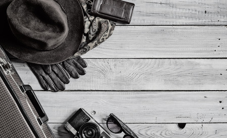 Man's hat and retro accessories for travel on a white painted wooden surfaceの写真素材