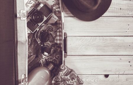 Man's hat and retro accessories for travel on a white painted wooden surfaceの写真素材