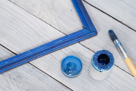 Blue frame, paint and brush on white boards backgroundの写真素材