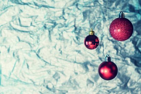 Red Christmas balls on a silvery backgroundの写真素材