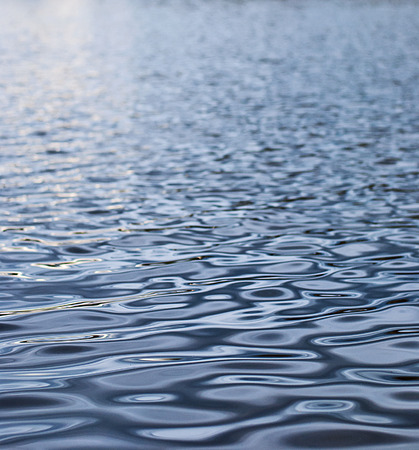 Small waves in the sea, illuminated by sunlight