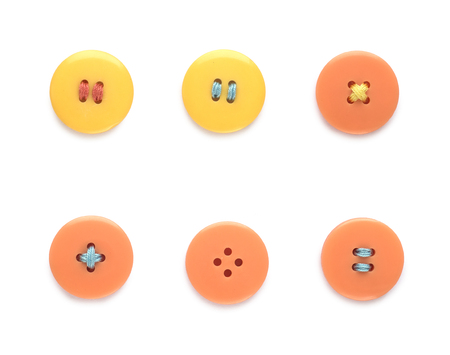 Yellow and orange buttons isolated on whiteの写真素材