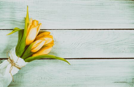 Bouquet of yellow tulips on a white wooden tableの写真素材