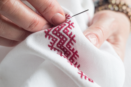 Hands of a woman embroidering a geometric ornamentの写真素材