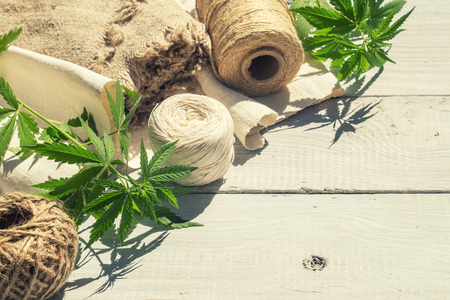 Hemp canvas and threads on a white wooden surfaceの写真素材