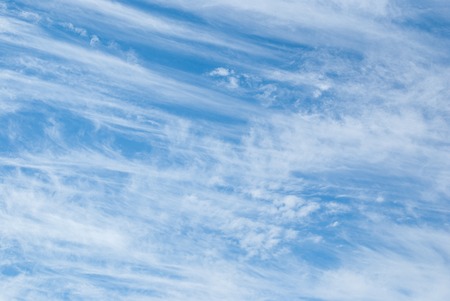 White cumulus and cirrus clouds in the blue skyの写真素材