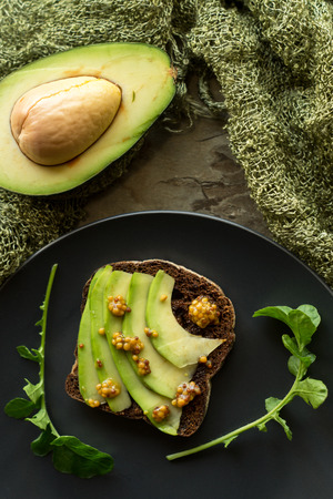 Rye bread with avocado and mustard seeds. Healthy food breakfast conceptの写真素材