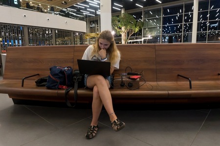 Amsterdam, Netherlands - August 26, 2017: Young girl in SchipholAmsterdam, Netherlands - August 26, 2017: Young girl in Schiphol airport lounge in Amsterdamのeditorial素材
