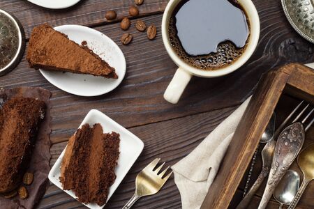 Slices of truffle chocolate cake and coffee on the wooden table. Top viewの写真素材