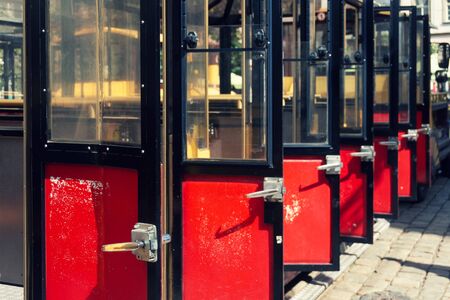 Row of open red and black doors on a sightseeing tram