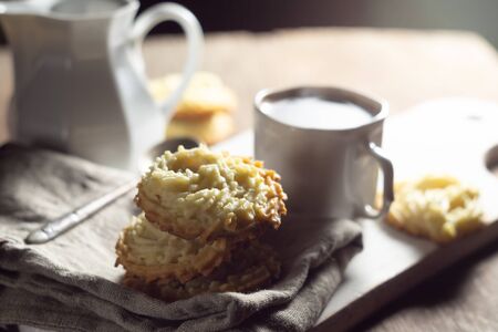 Coffee break. Shortbread cookies on a linen napkin and a cup of coffeeの写真素材