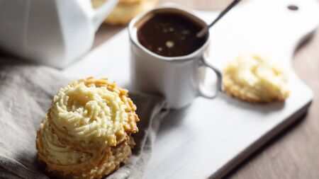 Coffee break. Shortbread cookies on a linen napkin and a cup of coffeeの写真素材