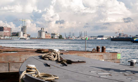 City panorama and mooring ropes at the port in Amsterdam, Netherlandsの写真素材