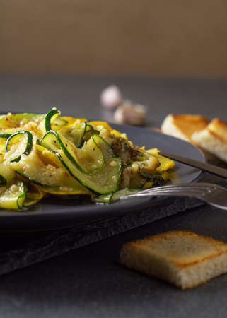 Fried zucchini with melted cheese and garlic inの写真素材