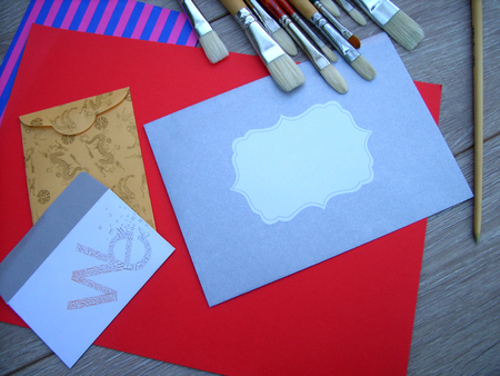 envelope, letter and brushes on colored paperの写真素材