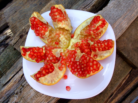 ripe pomegranate on a plateの写真素材