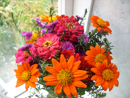 bouquet of bright flowers on the windowの写真素材