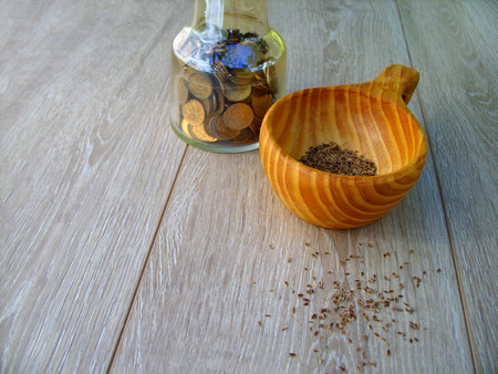seeds and coins on a wooden tableの写真素材