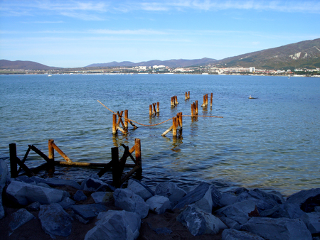 ruined pier and stones near the seaの写真素材