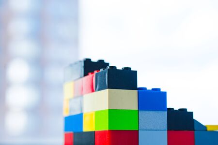 a scattering of many colored blocks from the designer. a house made of colored cubes from the...