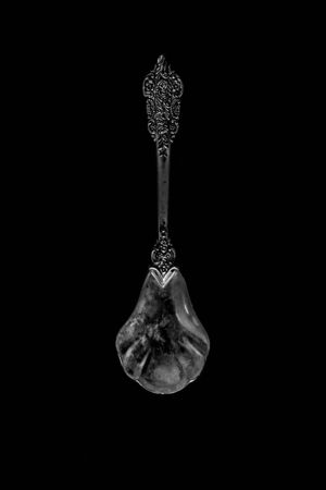 decorative spoon on a dark background. the view from the topの写真素材