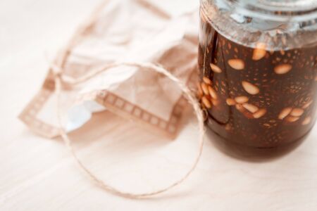 pine cone jam in a glass jar on a pastel background. vegetarian sweet dessert close-up, copy the place for the text. Cold medicineの写真素材