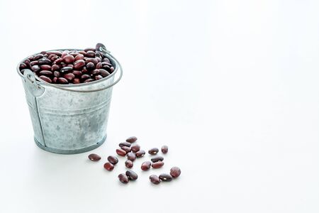 harvesting red beans. red beans in a small metal bucket. free space for text