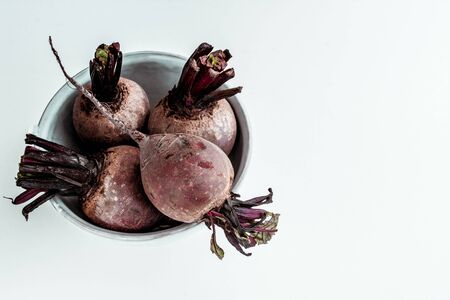 the yield of red beet. concept of ingredients for cooking. four roots of the beets on the plate. beetroot for cooking borschtの写真素材
