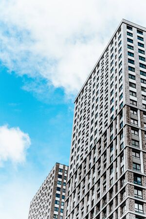 two new buildings against the blue sky. construction of new apartment buildings. developer investment in the construction. Completion of constructionの写真素材