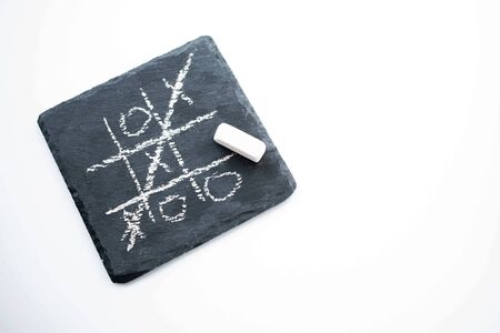 game TIC TAC toe on a black stone. the view from the topの写真素材