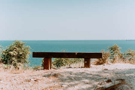 wooden bench on the top of the mountain with a view of the sea. background imageの写真素材
